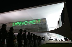 FILE - In this March 21, 2016 file photo, soldiers stand guard outside Planalto presidential palace where protesters have projected the word "Impeachment" on the building, as they call for the impeachment of Brazil's President Dilma Rousseff in Brasilia, Brazil. Rousseff is facing impeachment for alleged mismanagement of state funds. She's denied wrongdoing and claims the effort is a coup against her government. The process has several stages and could drag on for months. (AP Photo/Eraldo Peres, File)