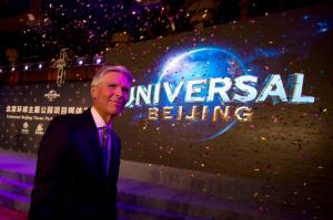 FILE - In this Monday, Oct. 13, 2014, file photo, Tom Williams, chairman and chief executive officer of the Universal Parks and Resorts, leaves after a ceremony to announce the Universal Beijing theme park in Beijing. Comcast, in a deal announced Thursday, April 28, 2016, is buying DreamWorks Animation, the film company behind the Shrek, Madagascar and Kung Fu Panda franchises, strengthening its presence in the important and growing business of childrens entertainment. Comcast also owns Universal theme parks in Florida and California and the Wet n Wild water park in Orlando, Florida. It has a majority stake in Universal Studios Japan and plans to open a theme park in Beijing. (AP Photo/Ng Han Guan, File)