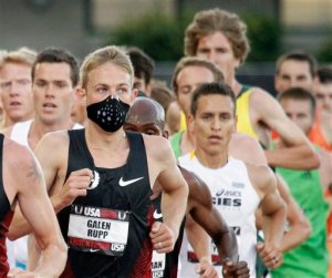 FILE - In this June 23, 2011 file photo, a runner wears a mask for allergies during the U.S. track and field championships in Eugene, Ore. A report issued Monday, April 4, 2016, by the Obama Administration listed how global warming will make the air dirtier, water more contaminated and food more tainted. It warned of diseases, such as those spread by ticks and mosquitoes, longer allergy seasons, and thousands of heat wave deaths.  (AP Photo/Don Ryan, File)