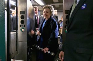 FILE - In this April 7, 2016 file photo, Democratic presidential candidate Hillary Clinton holds her Metrocard as she goes through the turnstile to enter the subway in the Bronx borough of New York. Clinton, Bernie Sanders and Donald Trump are all boasting about their New York City credentials. But who really makes the cut as  a local legend? We put the candidates to the test with a "New Yorker Scorecard."  (AP Photo/Richard Drew, File)