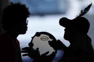 People sing songs in a camp set up by supporters of President Dilma Rousseff in Brasilia, Brazil, Friday, April 15, 2016. The lower chamber of Brazil's Congress on Friday began a debate on whether to impeach Rousseff, a question that underscores deep polarization in Latin America's largest country and most powerful economy. The crucial vote is slated for Sunday. (AP Photo/Eraldo Peres)