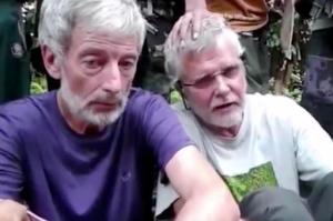 This image made from undated militant video, shows Canadians John Ridsdel, right, and Robert Hall. Canada's Prime Minister Justin Trudeau confirmed that the decapitated head of a Caucasian male recovered Monday, April 25, 2016, in the southern Philippines belongs to Ridsdel, who was taken hostage by Abu Sayyaf militants in September 2015. (Militant Video via AP Video) NO SALES, MANDATORY CREDIT