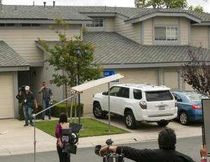 Members of the media stand outside the home of Syed Raheel Farook, the elder brother of San Bernardino gunman Syed Rizwan Farook, after the FBI served a warrant to the location, in Corona, Calif., Thursday, April 28, 2016.  Syed Raheel Farook was arrested with two others Thursday in what prosecutors say was a marriage scheme to fraudulently allow one of them to remain in the United States. (AP Photo/Damian Dovarganes)
