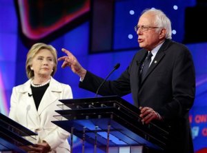 Democratic presidential candidate Sen. Bernie Sanders, I-V.t, right, speaks as Hillary Clinton listens during the CNN Democratic Presidential Primary Debate at the Brooklyn Navy Yard on Thursday, April 14, 2016 in New York. (AP Photo/Seth Wenig)