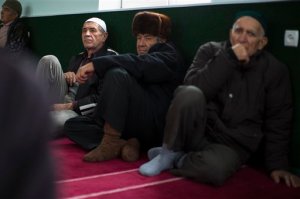 FILE  In this file photo taken on Friday, Oct.  24, 2014, Crimea Tatar men wait for the beginning of Friday's prayer inside a mosque in Sary-Su, Crimea. The chief prosecutor of Crimea has ordered a suspension of the council representing the region's Tatar ethnic minority. Tatars make up about 15 percent of the regions nearly 2 million people and have been broadly opposed to Russias annexation of the peninsula from Ukraine in 2014. (AP Photo/Alexander Zemlianichenko, file)
