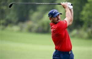 Scott Brown hits his second shot on the 15th hole during the first round of the Houston Open golf tournament, Thursday, March 31, 2016, in Humble, Texas. (AP Photo/Eric Christian Smith)