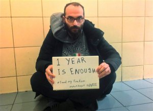 In this photo provided by Syrian refugee Fadi Mansour, Mansour is pictured holding a placard reading: '1 year is enough #I need my freedom', at Istanbul's Ataturk airport, Tuesday, March 15, 2016. Amnesty International is calling for the immediate release of the Syrian national, who initially fled Syria in August 2012 to avoid military service and has been detained at Istanbul's Ataturk Airport in "inhumane conditions" for one year. According to him and the organisation, he has been held since March 15, 2015 at the airport's "Problematic Passengers' Room," which has no natural light or beds. The rights group said such a prolonged detention "may amount to cruel, inhuman or degrading treatment, prohibited under domestic and international law". There was no immediate comment from Turkish officials. (Photo/Fadi Mansour via AP)