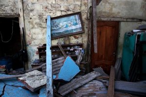 A framed print of The Last Supper hangs in the earthquake-damaged kitchen of Rene Macias, in Manta, Ecuador, Wednesday, April 20, 2016. Ecuadoreans began burying loved ones felled by the country's deadliest earthquake in decades, while hopes faded that more survivors will be found. (AP Photo/Rodrigo Abd)