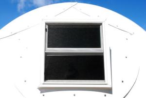 In this Friday, April 22, 2016 photo, the window of a dome-shaped shelter is shown at the First Assembly of God church in Honolulu. The church is looking into an unexpected solution to state's homeless crisis: they're planning to erect Alaska-made igloos to house homeless families. The snow-inspired dome-shape structures would appear at first glance to be a misfit among the island state's palm trees and sandy beaches, but their bright fiberglass exterior reflects the sun, shading those inside. (AP Photo/Caleb Jones)
