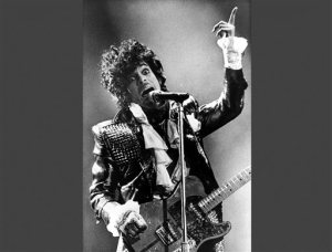 FILE - In this Jan. 22, 1985 file photo, Prince performs in concert at Riverfront Coliseum during his Purple Rain Tour in Cincinnati, Ohio. Prince's publicist has confirmed that Prince died at his home in Minnesota, Thursday, April 21, 2016. He was 57. (AP Photo/Rob Burns, File)
