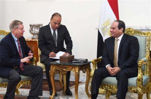In this photo provided by Egypt's state news agency, MENA, Egyptian President Abdel-Fattah el-Sissi, right meets with Republican Sen. Lindsey Graham, left, at the office of the Presidency in Cairo, Egypt. On Sunday, Graham told reporters in Cairo, that Republican candidate Donald Trumps campaign does not mean that the U.S. has fundamentally changed in terms of the way we view the world, and even if he wins, the congress will be around doing its job. (MENA via AP) MANDATORY CREDIT