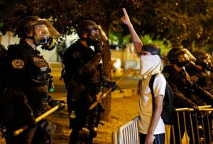 Riot police block off the Albuquerque Convention Center to anti-Trump protests following a rally and speech by Republican presidential candidate Donald Trump at the convention center where the event was held, in Albuquerque, N.M., Tuesday, May 24, 2016. (AP Photo/Brennan Linsley)