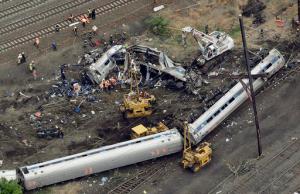 FILE- In this Wednesday, May 13, 2015 file photo, emergency personnel work at the scene of a Tuesday night derailment in Philadelphia of an Amtrak train headed to New York. The National Transportation Safety Board is scheduled to meet Tuesday, May 17, 2016, to detail the probable cause of last year's fatal derailment. (AP Photo/Patrick Semansky, File)
