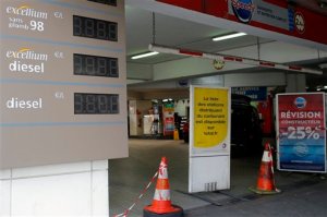 A red and white ribbon with construction cones prevents to enter in a closed gas station in Paris, Wednesday, May 25, 2016. France has started using its fuel reserves to deal with gasoline shortages caused by strikes and protests over a bill weakening worker protections. (AP Photo/Francois Mori)