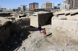 In this Monday, May 30, 2016 photo, Afghan girls play near their temporary home in a camp for internally displaced people in Kabul, Afghanistan. Amnesty International said Tuesday, May 31, that more than 1.2 million Afghans have been forced to flee their homes due to violence in the past three years and urged the Kabul government and the international community to tackle the country's growing crisis of refugees internally displaced by war. (AP Photo/Rahmat Gul)