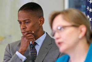 Halifax County Attorney Tracy Quackenbush Martin, right, gestures as she delivers a report on the death of a black man, Linwood Lambert Jr., in police custody as Richmond Commonwealth Attorney Michael Herring, left, listens during a press conference in Halifax, Va., Tuesday, May 3, 2016. In a report released Tuesday, Halifax County Commonwealths Attorney Tracy Quackenbush Martin said there's no evidence to suggest the officers, who used stun guns multiple times on Lambert before his death, deliberately caused or wanted Lambert Jr.'s death. Lambert died in May 2013 after being taken into custody by South Boston Police Officers. (AP Photo/Steve Helber)