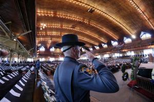 A police officer salutes as he stands guard near markers for fallen police officers at Ocean Grove's Great Auditorium as officers from around the state gather for the Police Chiefs Foundation's 32nd annual memorial service remembering officers who died in the line of duty, Tuesday, May 24, 2016, in the Ocean Grove section of Neptune, N.J. (AP Photo/Mel Evans)