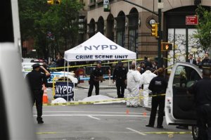 Police work at the scene following a fatal shooting in New York on Wednesday, May 18, 2016. The incident occurred near a few of Broadway's big theaters. (AP Photo/Seth Wenig)