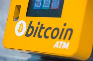 File - This is a Oct. 16, 2015 file photo of a  Bitcoin ATM. An Australian man long thought to be associated with the digital currency Bitcoin has publicly identified himself as its creator. BBC News said Monday, May 2, 2016 that Craig Wright told the media outlet he is the man previously known by the pseudonym Satoshi Nakamoto. The computer scientist, inventor and academic says he launched the currency in 2009 with the help of others. (Dominic Lipinski/PA via AP, File) UNITED KINGDOM OUT NO SALES NO ARCHIVE