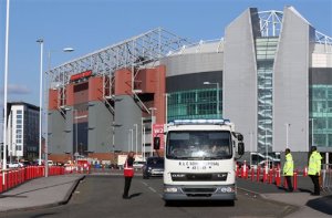 In this photo taken on Sunday, May 15, 2016, a police bomb squad unit leaves Old Trafford stadium after the final soccer match of the season between Manchester United and AFC Bournemouth was abandoned due to a suspect package being found inside the stadium. Greater Manchesters interim mayor has called for an inquiry into a security alert triggered by a fake bomb left behind at a sports stadium after a training exercise. The discovery of the dummy bomb on Sunday prompted the evacuation of Manchester Uniteds stadium, Old Trafford. Police say the bomb discovered in a toilet just before kickoff had been left by a private company after a drill using search dogs. (Martin Rickett/PA via AP) UNITED KINGDOM OUT    -    NO SALES   -   NO ARCHIVES