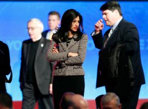 In this photo taken Dec. 19, 2015, Huma Abedin, center, aide to Hillary Clinton, stands on stage after a Democratic presidential primary debate in Manchester, N.H. FBI agents probing whether Hillary Clintons use of a private email server imperiled government secrets appear close to completing their work, a process experts say will likely culminate in a sit-down with the former secretary of state.  (AP Photo/Jim Cole)