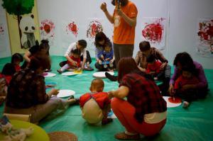 In this Wednesday, May 11, 2016 photo, children accompanied by their parents and caretakers, attend an art class at the I Love Gym center in Beijing. Chinas decision to allow all married couples to have two children is driving a surge in demand for fertility treatment among older women, putting heavy pressure on clinics and breaking down past sensitivities, and even shame, about the issue. The rise in in vitro fertilization points to the deferred dreams of many parents who long wanted a second child, but were prevented by a strict population control policy in place for more than 30 years. (AP Photo/Andy Wong)