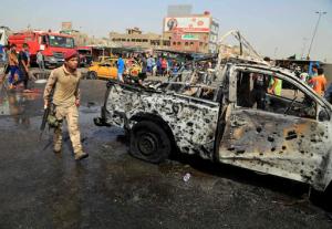 Security forces and citizens inspect the scene after a suicide car bomb hit a crowded outdoor market in Baghdad's eastern Shiite neighborhood of Sadr City, Iraq, Tuesday, May 17, 2016. A wave of bombings struck outdoor markets in Shiite-dominated neighborhoods of Baghdad on Tuesday, killing and wounding dozens of civilians, officials said, the latest in deadly militant attacks far from the front lines in the country's north and west where Iraqi forces are battling the Islamic State group. (AP Photo/Karim Kadim)