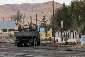 In this Thursday, April 14, 2016 photo, Russian soldiers are seen inside a Russian Vehicle at the ancient city of Palmyra in the central city of Homs, Syria. An American heritage organization says the Russian military is constructing a new army base in the central Syrian town of Palmyra, within the protected zone that holds the archaeological site listed by UNESCO as world heritage. (AP Photo/Hassan Ammar)