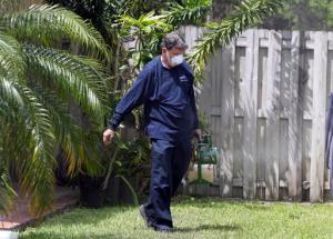 In this photo taken April 12, 2016, Giraldo Carratala, an inspector with the Miami- Dade County, Fla. mosquito control unit, sprays pesticide in the yard of a home in Miami, Fla. Beg, borrow and steal: Zika preparation involves a bit of all three as federal, state and local health officials try to get a jump on the mosquito-borne virus while Congress haggles over how much money they really need. With the money in limbo, it's all about shifting resources. (AP Photo/Lynne Sladky)