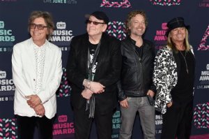 Tom Petersson, from left, Rick Nielsen, Daxx Nielsen and Robin Zander, of Cheap Trick, arrive at the CMT Music Awards at the Bridgestone Arena on Wednesday, June 8, 2016, in Nashville, Tenn. (Photo by Sanford Myers/Invision/AP)