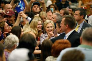 Democratic presidential candidate Hillary Clinton takes a selfie with supporters at a rally at Sacramento City College, Sunday, June 5, 2016, in Sacramento, Calif. (AP Photo/John Locher)