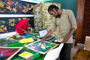 In this May 28, 2016 photo, art student Rubens Corneille, right, prepares his work during the Mixed Media class with Tessa Mars at the resurrected Centre dArt or Art Center, in Port-au-Prince, Haiti. The Haitian nonprofit Knowledge & Freedom Foundation and a French family foundation are the main providers of institutional support for the Centre dArt. (AP Photo/Dieu Nalio Chery)