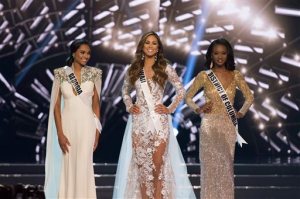 Finalists Miss Hawaii Chelsea Hardin, center, Miss District of Columbia Deshauna Barber, right, and Miss Georgia Emanii Davis, left, stand during the 2016 Miss USA pageant in Las Vegas, Sunday, June 5, 2016. (Jason Ogulnik/Las Vegas Review-Journal via AP) LOCAL TELEVISION OUT; LOCAL INTERNET OUT; LAS VEGAS SUN OUT