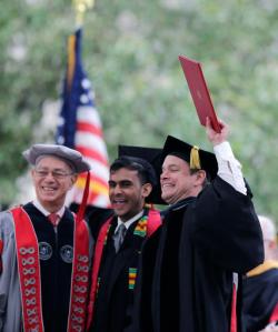 Actor Matt Damon holds up an "Honorary Pirate Certificate" as he is honored following his address at the Massachusetts Institute of Technology's commencement in Cambridge, Mass., Friday, June 3, 2016. Damon won an Academy Award for co-writing the 1997 film "Good Will Hunting", where he portrayed a mathematically gifted MIT janitor. With Damon are MIT Chairman Robert Millard, left, and Class of 2016 President Anish Punjabi. MIT does not confer an honorary degree to the commencement speaker. (AP Photo/Charles Krupa)