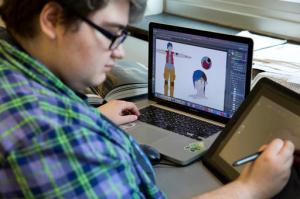 In this Friday, May 13, 2016, photo, animation and gaming arts student Lindsey O'Brien works on her project at Moore College of Art & Design in Philadelphia. Students from the all-female arts college stood out without even trying when they attended a conference for video game developers last year. OBrien says they were basically the only girls in the room. But the male-dominated video game industry is changing as more women get involved in designing, playing and reviewing the games. (AP Photo/Matt Rourke)