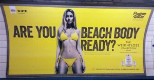 FILE - This is an April 27, 2015 file photo  of a Protein World advert displayed in an underground station in London. London Mayor Sadiq Khan has banned advertising that promotes unhealthy body image on the city's subway network. Starting July 2016, Transport for London will not allow ads that cause pressure to conform to "unrealistic or unhealthy body shape."(Catherine Wylie/Pa, File via AP)