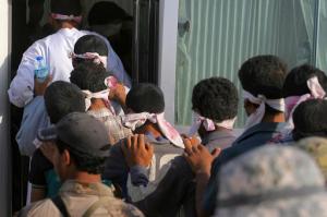 Blindfolded men are led to a bus after being detained during fighting between Iraqi security forces and Islamic State militants during a military operation to regain control of Fallujah, 40 miles (65 kilometers) west of Baghdad, Iraq, Wednesday, June 1, 2016. Since the operation began, the United Nations says they have received reports that some 500 men and boys have been detained for questioning as thousands of civilians have fled the citys mostly rural outskirts.(AP Photo/Anmar Khalil)