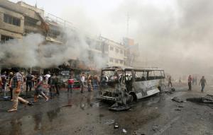 Civilians gather at the scene of a deadly suicide car bomb attack in the neighborhood of New Baghdad, Iraq, Thursday, June 9, 2016. Two separate suicide attacks in and outside the Iraqi capital have killed at least 27 people and wounded dozens. Officials say the deadliest bombing took place in New Baghdad, a commercial area of a majority Shiite neighborhood, killing over a dozen civilians. Another suicide bomber rammed his explosives-laden car into an Iraqi army checkpoint north of Baghdad, killing at least 12 people. (AP Photo/Hadi Mizban)