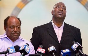 Terry Banks, right, speaks about his nephew, Corey Jones, next to Bishop Thomas Masters during a news conference at the Bible Church of God in Boynton Beach, Fla., Wednesday, June 1, 2016. Fired officer Nouman Raja was arrested Wednesday and charged with attempted murder and manslaughter in the Oct. 18, 2015, death of Jones, after a grand jury found the shooting was unjustified. (Greg Lovett/Palm Beach Post via AP)  MAGS OUT; TV OUT; NO SALES; MANDATORY CREDIT
