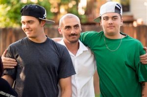 In this Friday, June 3, 2016 photo, Weldon Angelos, center, holds his sons Anthoney, left and Jesse in Sandy, Utah. Weldon Angelos, a Utah music producer who was ordered to 55 years behind bars for bringing guns to marijuana deals has been set free, after 12 years in prison and national outcry over the mandatory minimum sentencing laws that forced a federal judge to impose the lengthy term. (Rick Egan/The Salt Lake Tribune via AP) DESERET NEWS OUT; LOCAL TELEVISION OUT; MAGS OUT; MANDATORY CREDIT