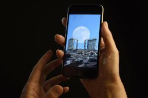 CORRECTS MONTH TO JUNE, NOT JULY - This June 21, 2016 photo shows a smartphone held for a photograph in New York. In a letter published Wednesday, June 22, 2016 in the New England Journal of Medicine, doctors detailed separate cases of two women who experienced "transient smartphone blindness" for months. Doctors discovered it was caused when they looked at their device with one eye while in bed in the dark _ and their other eye covered by a pillow. (AP Photo/Patrick Sison)