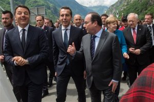 Italian Prime Minister Matteo Renzi, Austrian Chancellor Christian Kern, French President Francois Hollande, German Chancellor Angela Merkel and Swiss Federal President Johann Schneider-Ammann, from left to right, arrive at the southern portal after they drove by train through the Gotthard from north to south, on the opening day of the Gotthard rail tunnel,  at the fairground in Pollegio, Switzerland, Wednesday, June 1, 2016. The construction of the 57 kilometer long tunnel began in 1999, the breakthrough was in 2010.  (Gabriele Putzu/Keystone, Ti-Press via AP)