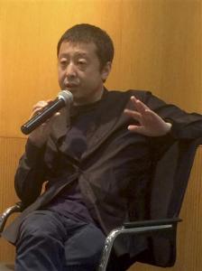In this Saturday, June 18, 2016 photo, Chinese director Jia Zhangke speaks at an event in Beijing. Jia says he will make a virtual reality film with a romantic story next year as he and viewers get used to the new medium. (AP Photo/Louise Watt)