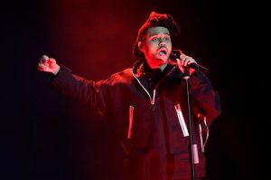 FILE - In this April 7, 2016, file photo, The Weeknd performs during the 2016 Echo Music Award ceremony in Berlin. Kanye West and The Weeknd will headline the first edition of the Meadows Music and Arts Festival in October 2016 in New York City. (AP Photo/Markus Schreiber, Pool, File)