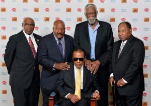 FILE - In this Sept. 27, 2014, file photo, back row from left, John Wooten, Jim Brown, Bill Russell, and Bobby Mitchell stand behind Muhammad Ali before the start of the Ali Humanitarian Awards ceremony in Louisville, Ky. The death of Muhammad Ali left a profound effect on many, even fellow legends.  (AP Photo/Timothy D. Easley, File)