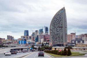 FILE - In this Feb. 19, 2016, file photo, The Trump International Hotel, the highest building, is seen in Baku, Azerbaijan. Just six months before he launched his presidential campaign, Donald Trump announced a new real estate project in Baku. The partner: the 35-year-old son of an Azerbaijani minister suspected by U.S. diplomats of corruption and laundering money for Irans military and described by them as notoriously corrupt. Now, only weeks after Ivanka Trump released a publicity video of the nearly finished project, references to the Baku project have disappeared from Trumps website. (AP Photo/Aida Sultanova, File)