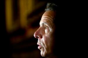 New York Gov. Andrew Cuomo talks to media members outside his office at the state Capitol on Tuesday, May 24, 2016, in Albany, N.Y. Cuomo says tightening campaign finance laws and fighting the heroin epidemic are two of his top priorities as lawmakers near adjournment. (AP Photo/Mike Groll)