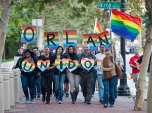 Several hundred supporters, led by Laura Kanter, at right, marched to Sasscer Park after a vigil at Calle Cuatro Plaza in support of the Orlando shooting victims Sunday, June 12, 2016, in Santa Ana, Calif.  (Kevin Sullivan/The Orange County Register via AP)