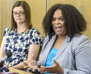 Jan DeMoure, left, and Emily Brown hold a news conference on Wednesday, May 18, 2016, at the Food Equality Initiative at the New Haven Seventh-Day Adventist Church in Overland Park, Kansas. The food pantry serves families, like DeMoure, coping with the high costs of food safe for children with food allergies or Celiac disease. (Allison Long/The Kansas City Star via AP) MANDATORY CREDIT