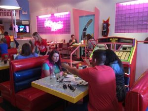 In this Wednesday, June 1, 2016 photo, customers eat at pop-up restaurant Saved by the Max in Chicago. A vacant restaurant space in Chicagos Wicker Park neighborhood has become a replica of The Max, the fictitious hangout from the TV sitcom "Saved by the Bell." (AP Photo/Terry Tang)
